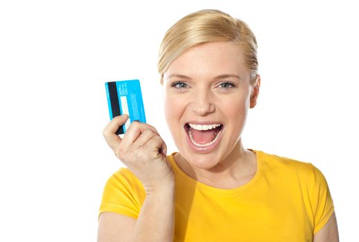 Blond sales girl posing with credit card and smiling at camera