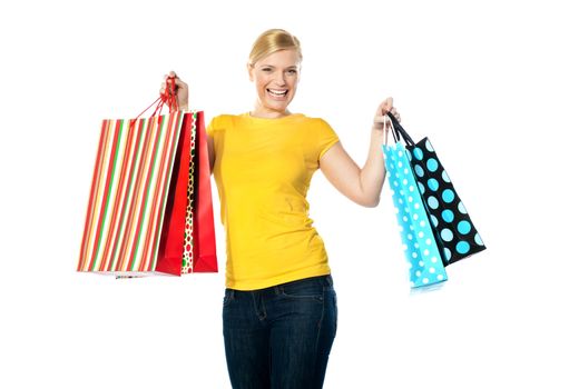 Smiling teenager posing with shopping bags
