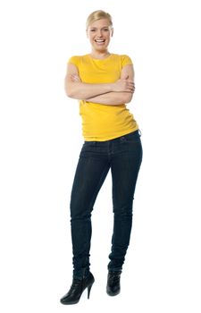 Stylish teenager posing with crossed arms dressed in t-shirt and jeans