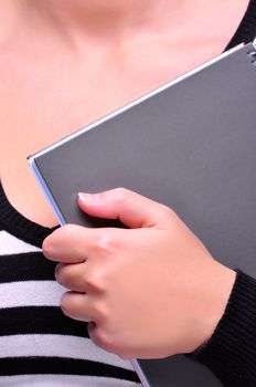 Closeup of a schoolgirl holding a notepad