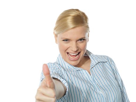 Happy young businesswoman gesturing thumbs-up againt white background