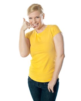 Attractive trendy girl showing calling gesture