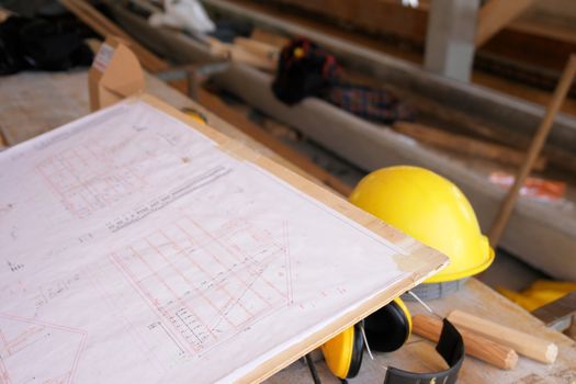 close-up of a hardhat and a plan...