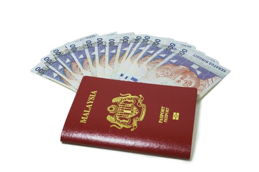 Malaysia passport and RM100 Notes.