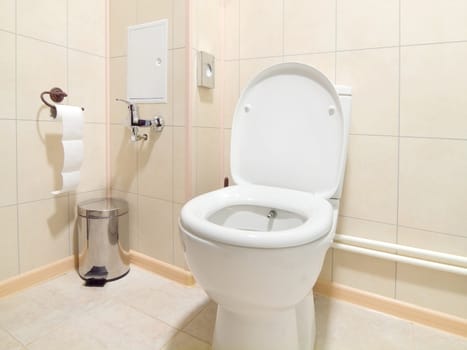 Toilet room interior with white water-closet