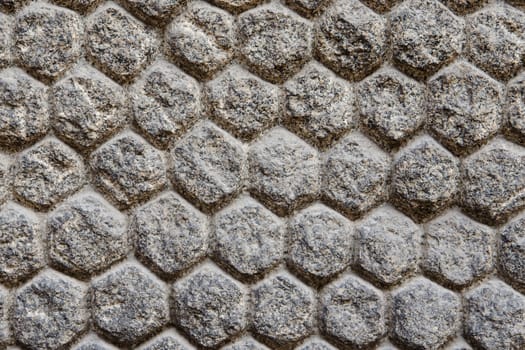 Texture of a wall with stones and masonry shaped of hexagons