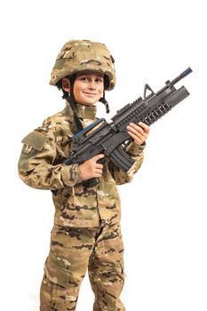 Young boy dressed like a soldier with rifle isolated on white