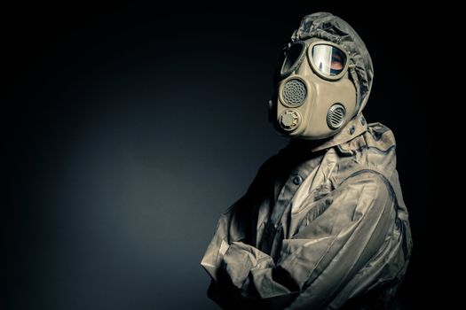 Man in protective suit against black background