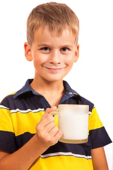 Сute boy is drinking milk. Schoolboy is holding a cup of milk isolated on a white background