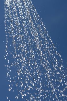 water drops falling from a shower outside