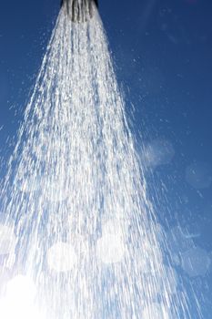 water drops falling from a shower outside