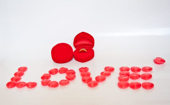 ring for love  and candy on white background