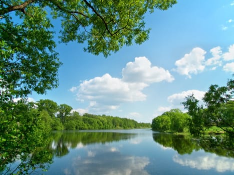 Summer river with bright blue sky and clouds