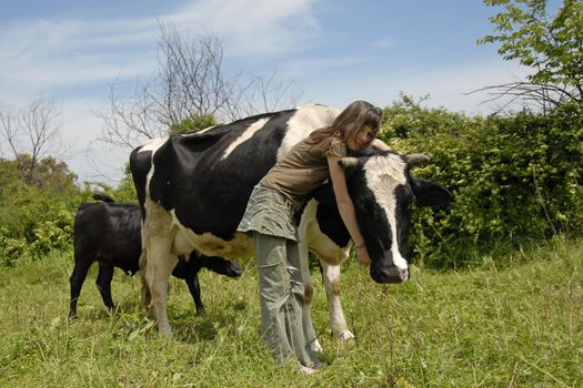 young teen and her friend black and white cow with her calf
