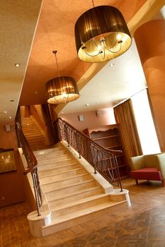 Spacious hall of hotel overlooking a wide ladder. inclined composition