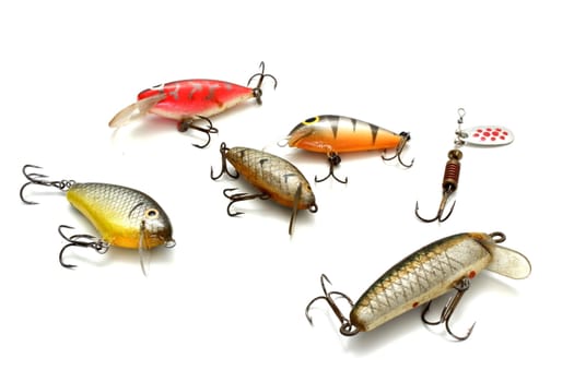 collection of small fishing lures over white background