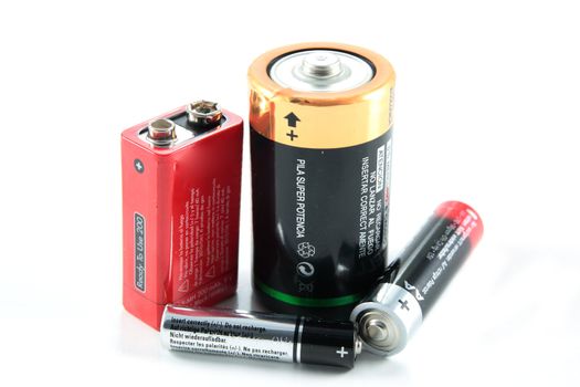 various types of rechargeable batteries and disposable horizontally on white background
