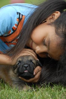 little girl and very young puppy belgian shepherd malinois