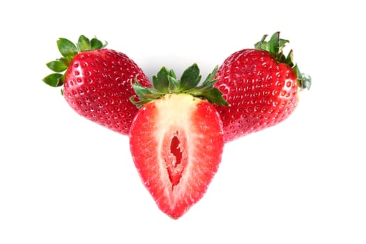 two whole strawberries and cut in half on white background