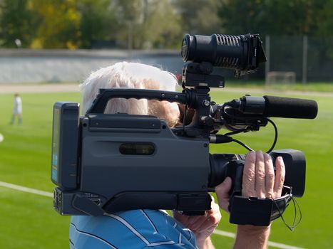 Cameraman at work outdoor sport recording