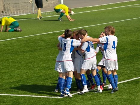 Football players celebrating goal