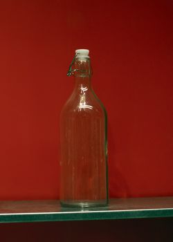 transparant bottle with a red abckground