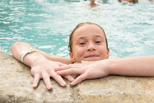 Smiling girl in a swimming pool