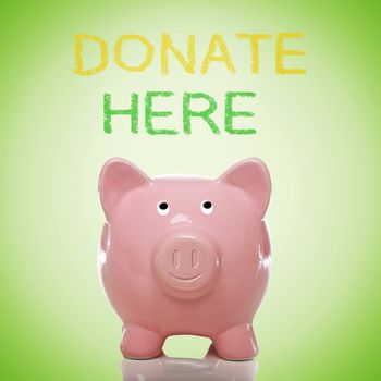Piggy bank with donate here text on green background