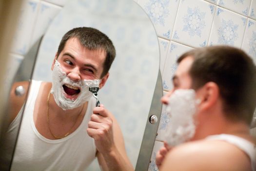 man shaving in his bathroom