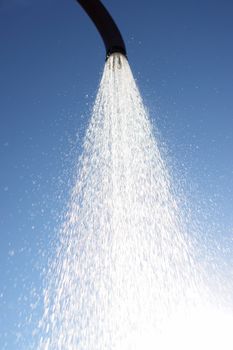 water drops falling from a shower outside