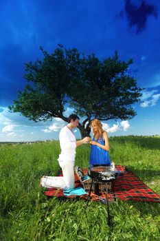 lovers on picnic cook steak