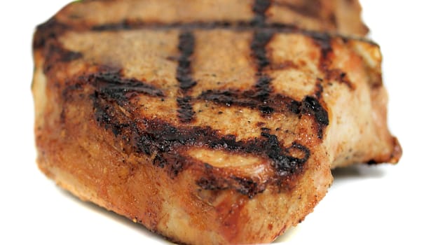 Fresh grilled beef steak on white plate close up