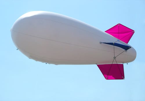 white airship in the blue sky landing away