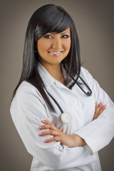 Smiling medical doctor with stethoscope on gray background