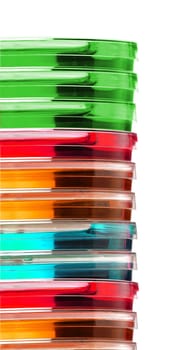 Stack of colorful Petri dishes on white background