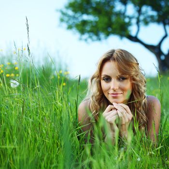  woman on the green grass under tree happy and smile