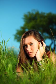 happy woman lay on green grass under tree