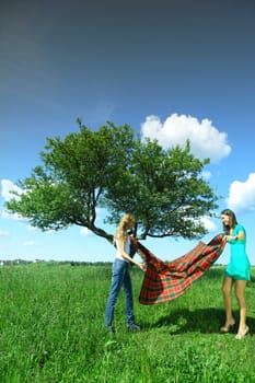 girlfriends on picnic in green grass