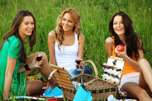 girlfriends on picnic in green grass