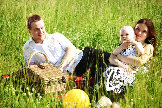  happy family on picnic in green grass