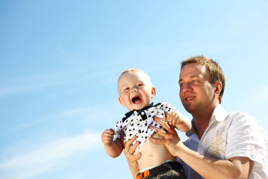 father and son in blue sky