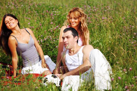 friends and dog in green grass field