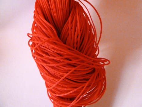 red string knot on a white background