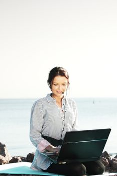 woman with laptop sea background