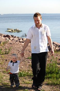 father and son walking on grass