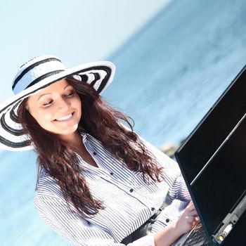 woman with laptop sea background