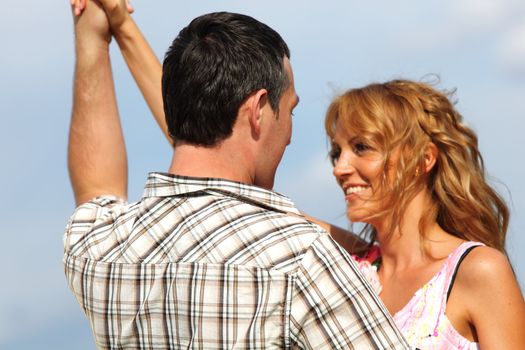 man and woman dance in the sky