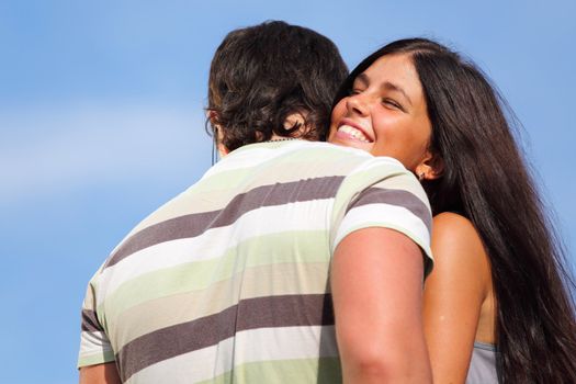 man and woman hug sky on background