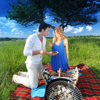 man and woman on picnic in green grass