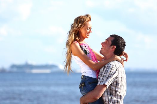 man and woman hug in the sky and sea on sea